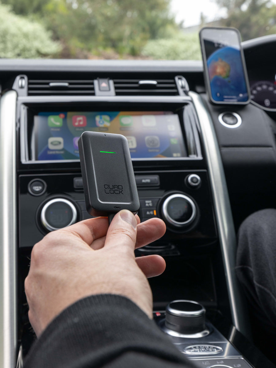 photo of wireless carplay adaptor plugged in to car and iPhone connected with CarPlay on car screen